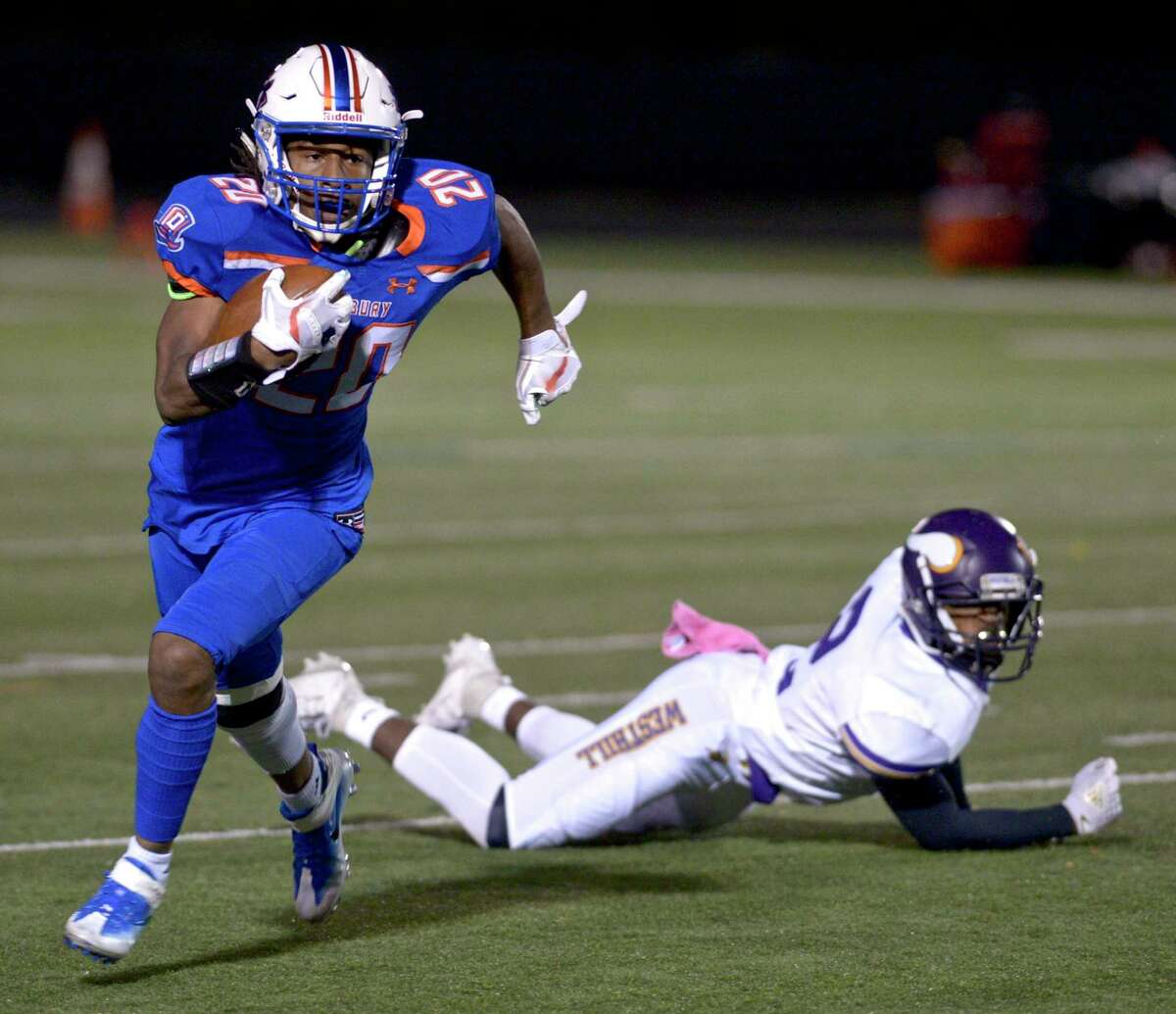 Danbury’s Artez Taft gets away from Westhill’s Sam Edouard during Friday’s game.
