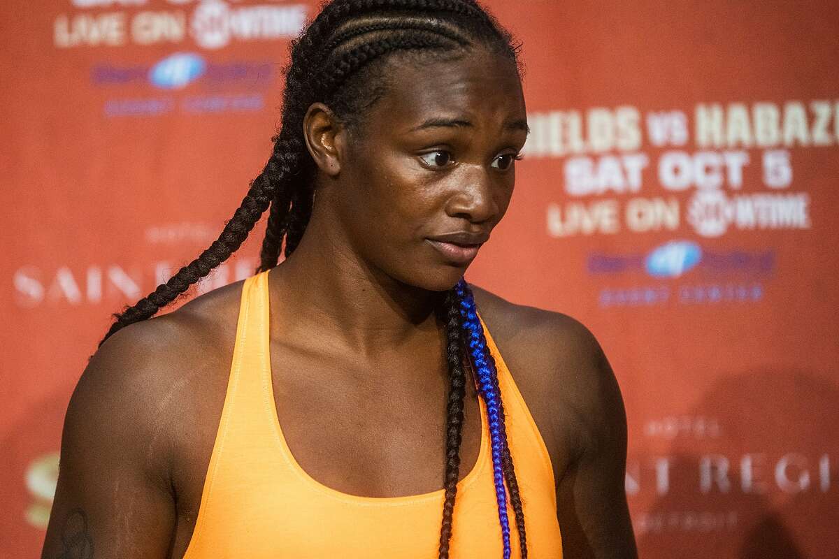 Boxer Claressa Shields walks out before her weigh-in minutes before her opponent Ivana Habazin's trainer Bashir Ali was punched by a man and fell to the ground, Friday, Oct. 4, 2019, in Flint, Mich. Ali was sent to McLaren Hospital in Flint to be treated. Habazin and Shields are scheduled to fight Saturday for the WBO and WBC super welterweight championships. (Jake May/The Flint Journal via AP)