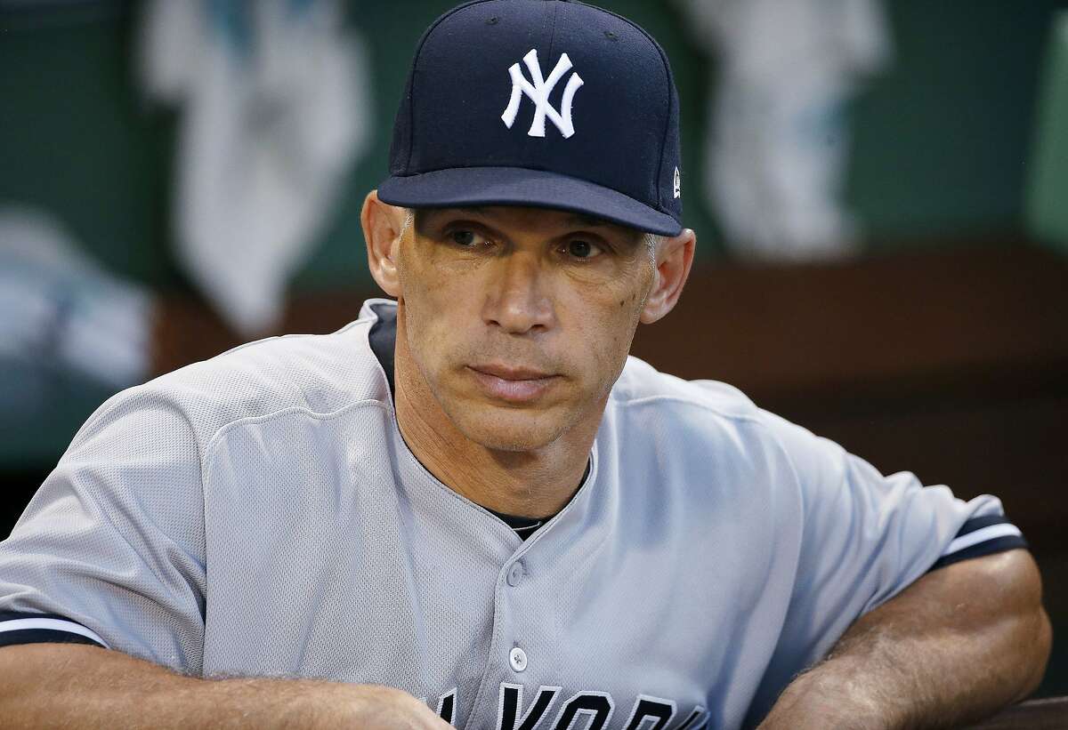 FILE - In this July 16, 2017, New York Yankees manager Joe Girardi stands in the dugout before the second game of the baseball team's doubleheader against the Boston Red Sox in Boston. Former Chicago Cubs catchers David Ross and Girardi will speak with the team next week about its managerial opening. The team also plans to interview first base coach Will Venable next week. Bench coach Mark Loretta interviewed for the job Thursday. The Cubs are searching for a successor to Joe Maddon, whose contract expired after the Cubs missed the playoffs this year for the first time since 2014. (AP Photo/Michael Dwyer, File)