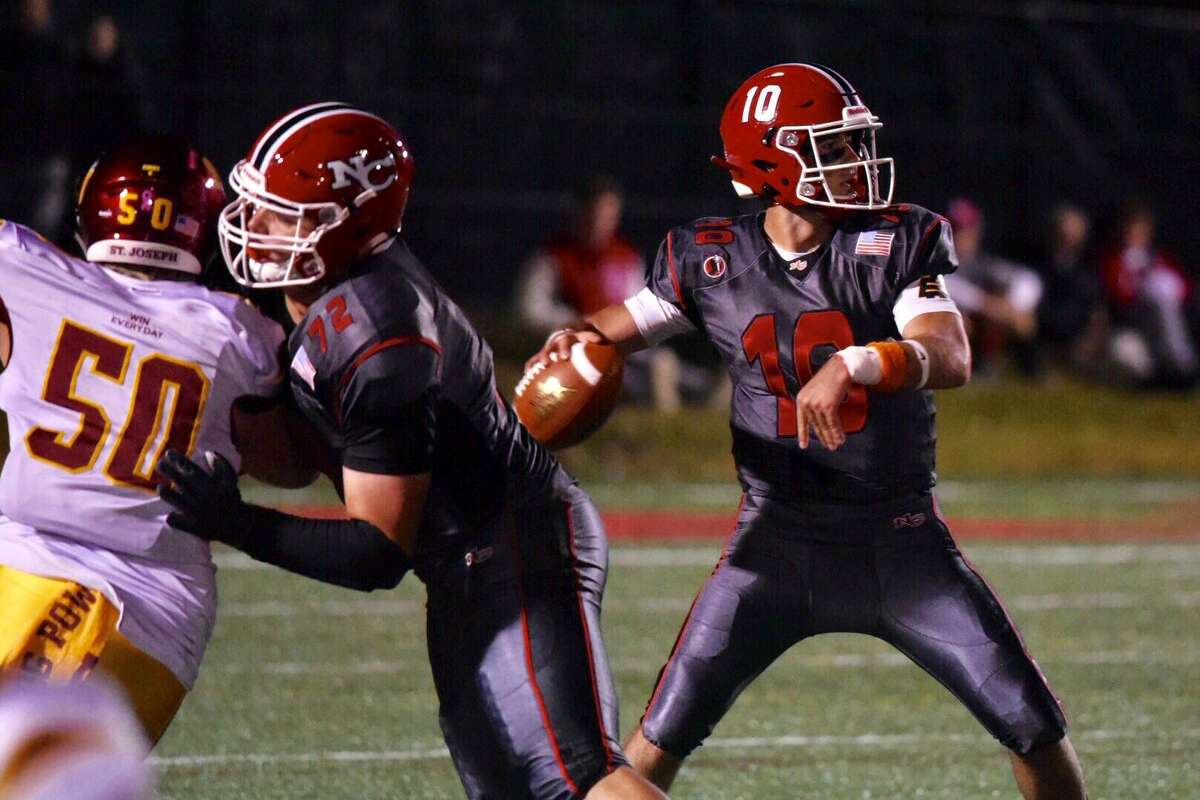 New Canaan’s Drew Pyne throws a pass while Ben Clay blocks during the Rams’ 58-14 loss to St. Joseph on Friday at Dunning Field.