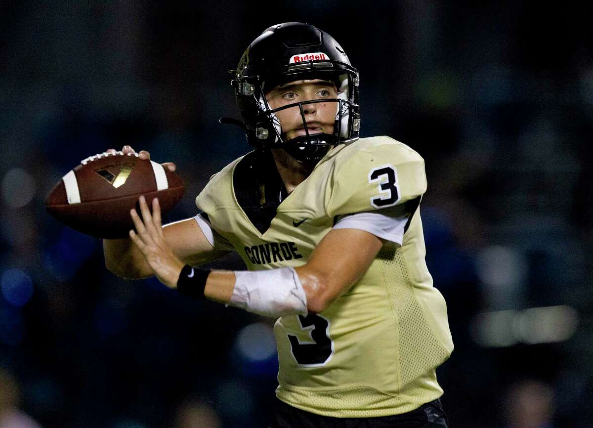 Conroe quarterback Christian Pack (3) drops back to pass during the fourth quarter of a District 15-6A high school football game at Buddy Moorhead Stadium, Friday, Oct. 4, 2019, in Conroe.