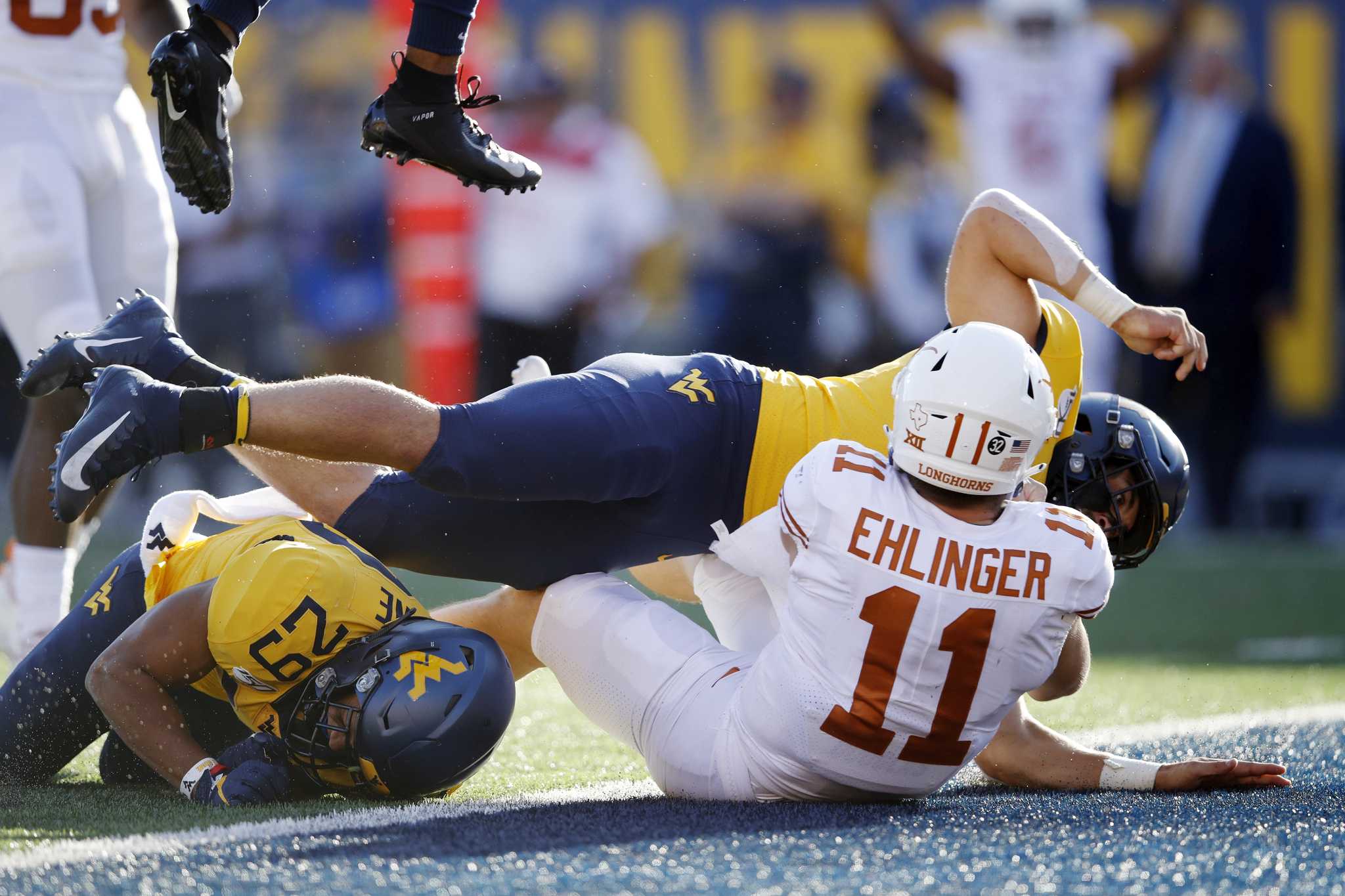 Ehlinger leads No. 11 Texas over West Virginia 42-31