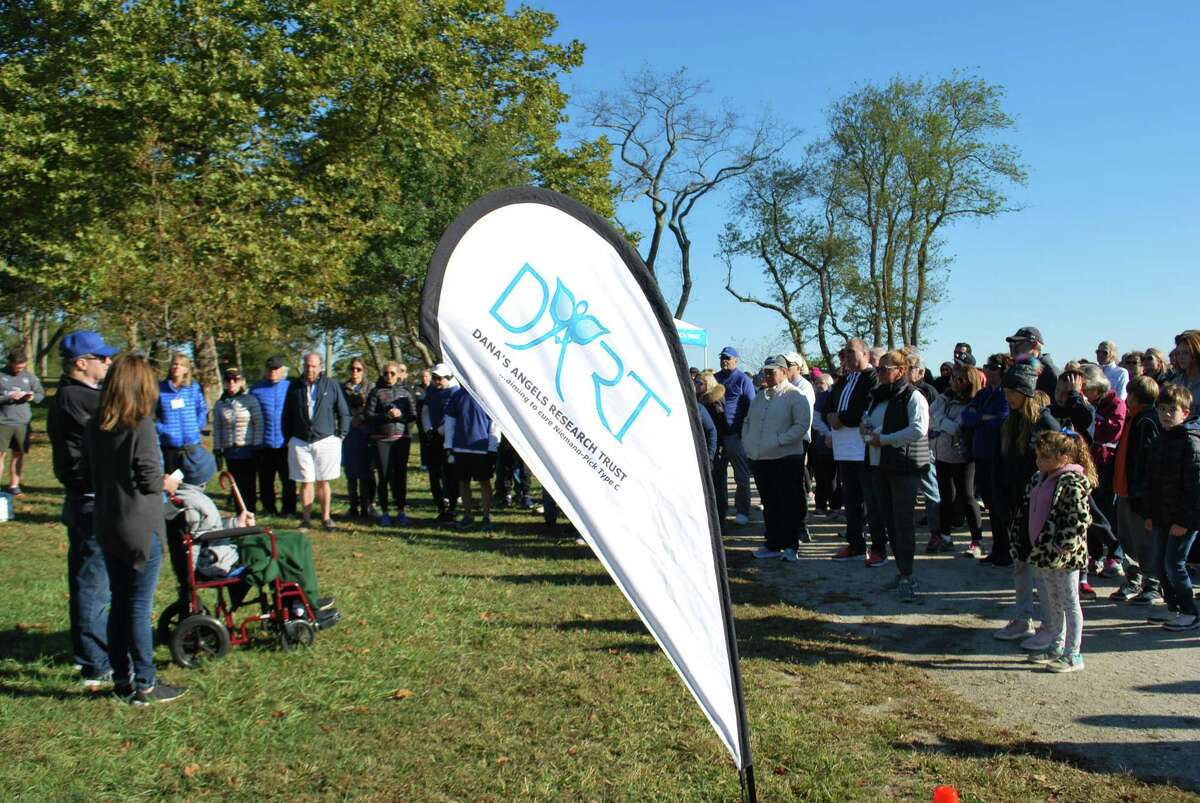 Andrea and Phil Marella of Greenwich, at left, the founders of the Dana’s Angels Research Trust, start the second annual DART to the Finish charity walk with their son Andrew on Saturday at Greenwich Point Park. The charity walk funds research into Niemann Pick disease type C.