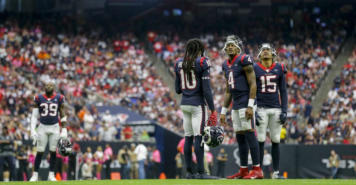 Houston Texans quarterback Deshaun Watson (4), and wide receivers DeAndre Hopkins (10) and Will Fuller (15) wait for a play to be reviewed during the fourth quarter of an NFL football game at NRG Stadium Sunday, Oct. 6, 2019, in Houston.