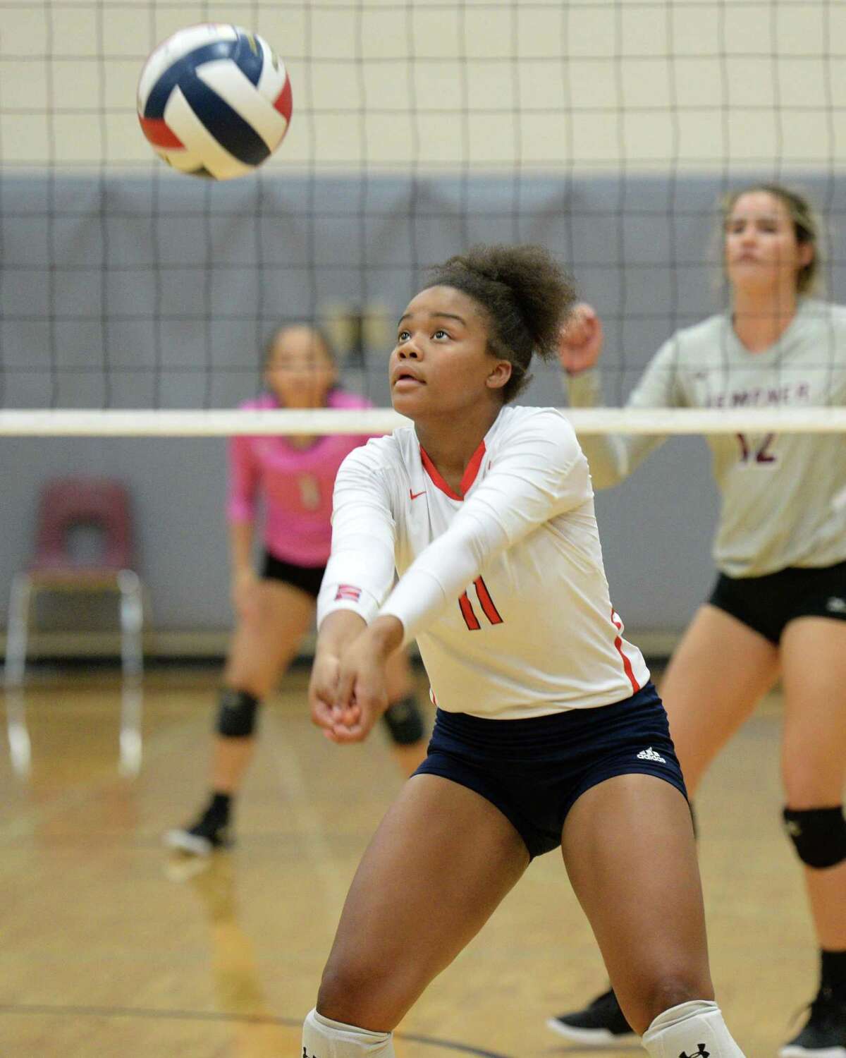 Madison Harris (11) of Alief Taylor digs for a ball during the second set of a volleyball match between the Kempner Cougars and the Alief Taylor Lions on Saturday, August 10, 2019 at Cinco Ranch HS, Katy, TX.