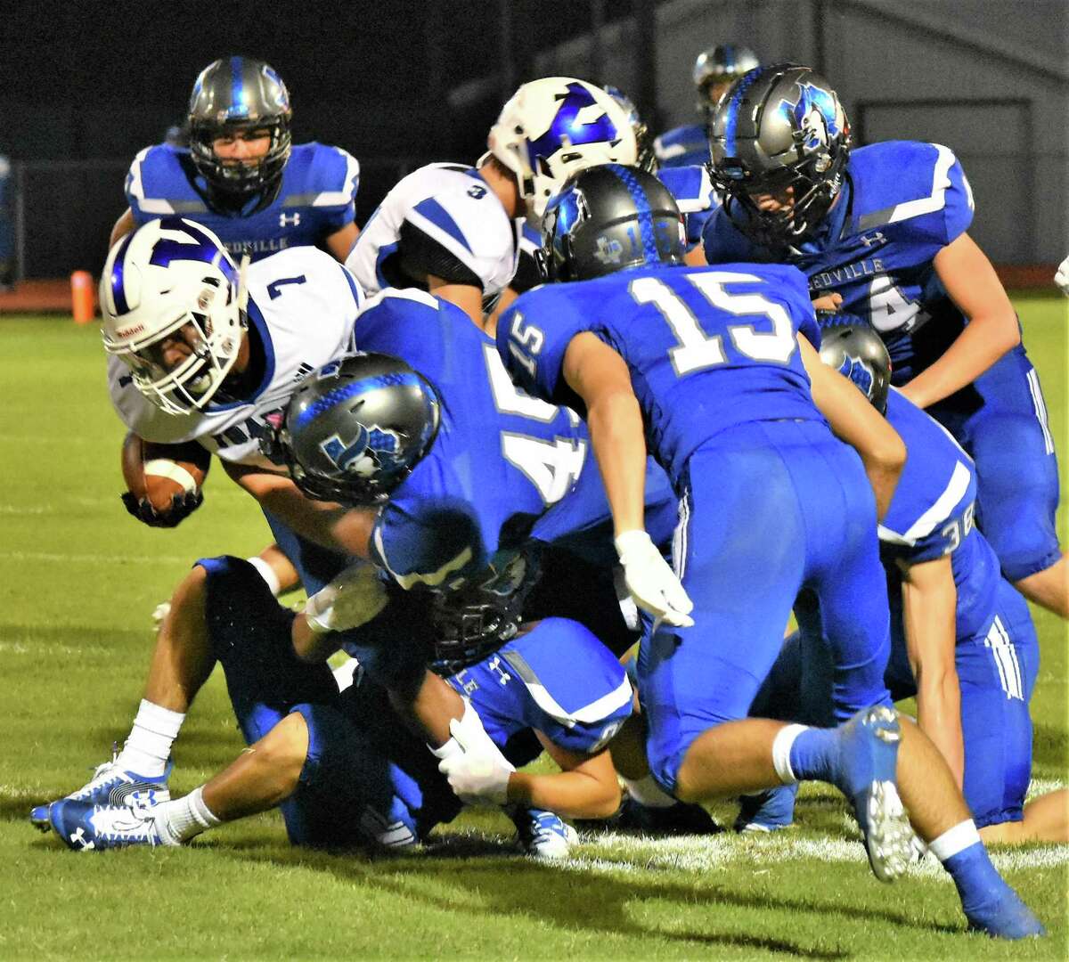 Andrew Valdez (45) and the Needville defense stop a Yoakum ball carrier as Cole Todd (15) closes in during their Sept. 20 game at Blue Jay Stadium.