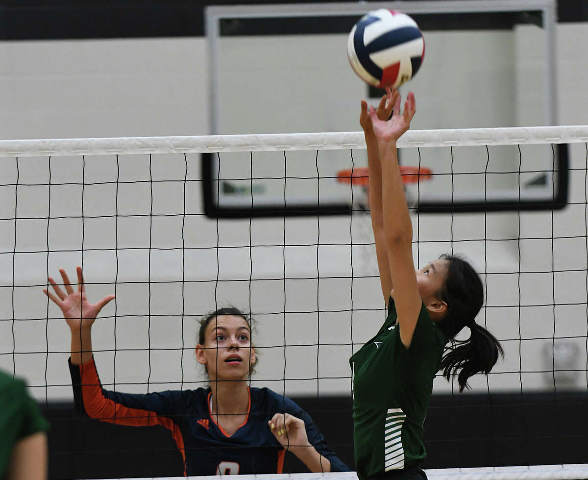 Bridgeland senior middle blocker Aidan Conner (9) works at the net against Cy Ridge senior setter Catherine Pham, right, during their pool play matchup in the 2019 Katy/Cy-Fair Volleyball Classic at Cy Parks High School on August 8, 2019.