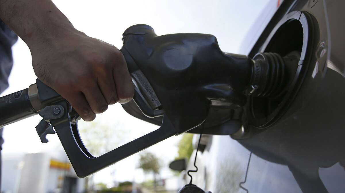 FILE - In this April 23, 2019, file photo, a motorist puts gas in his car at a Shell station in Sacramento, Calif. Escalating tensions in the Middle East and elsewhere could threaten oil supply, which could push the price of oil and gasoline higher. (AP Photo/Rich Pedroncelli, File)