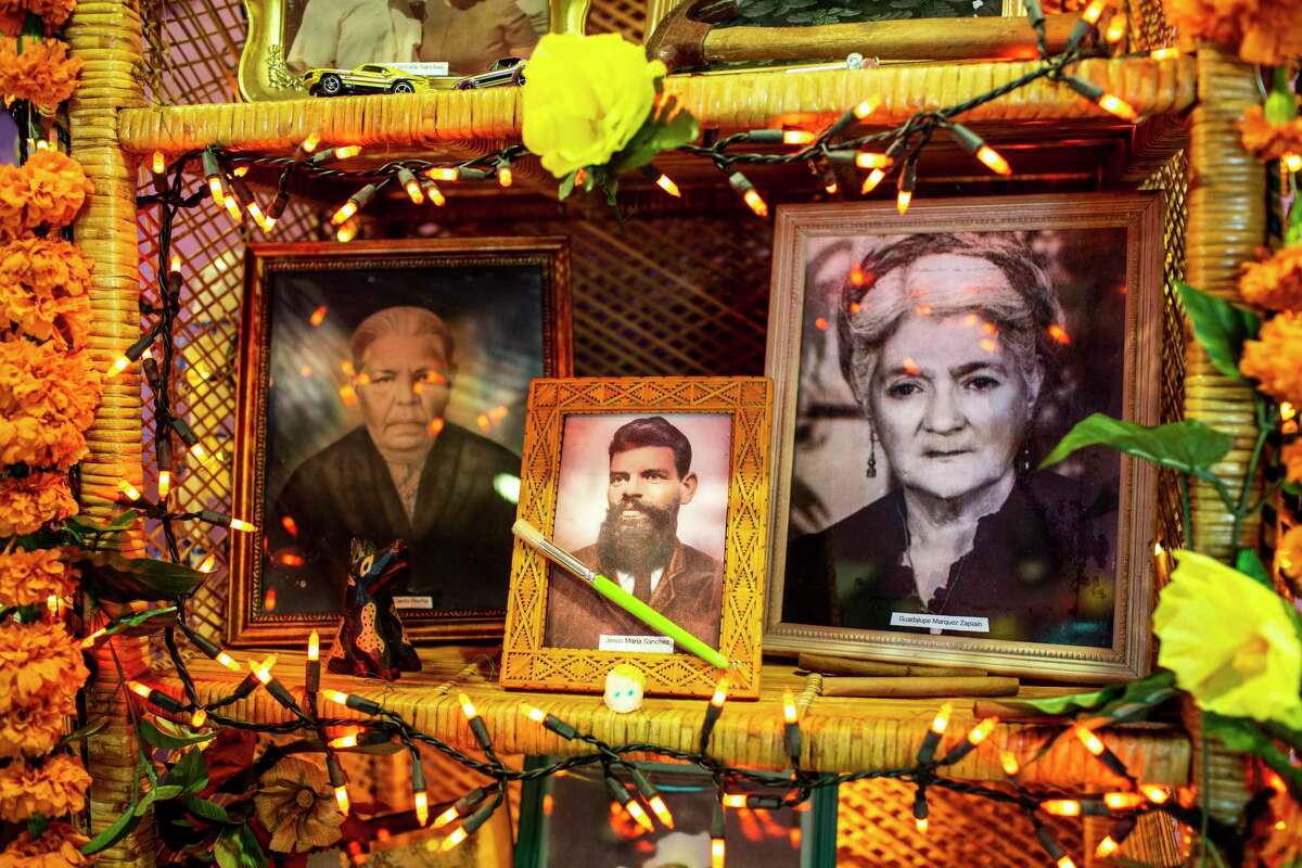 The altar of the Isabel and Enrique Sanchez family features pictures of their deceased family members at the Esperanza Peace & Justice Center's annual Dia de los Muertos Celebration on November 1, 2018. Center is pictured Enrique's great grandfather. Isabel is 95, her husband Enrique is 90.