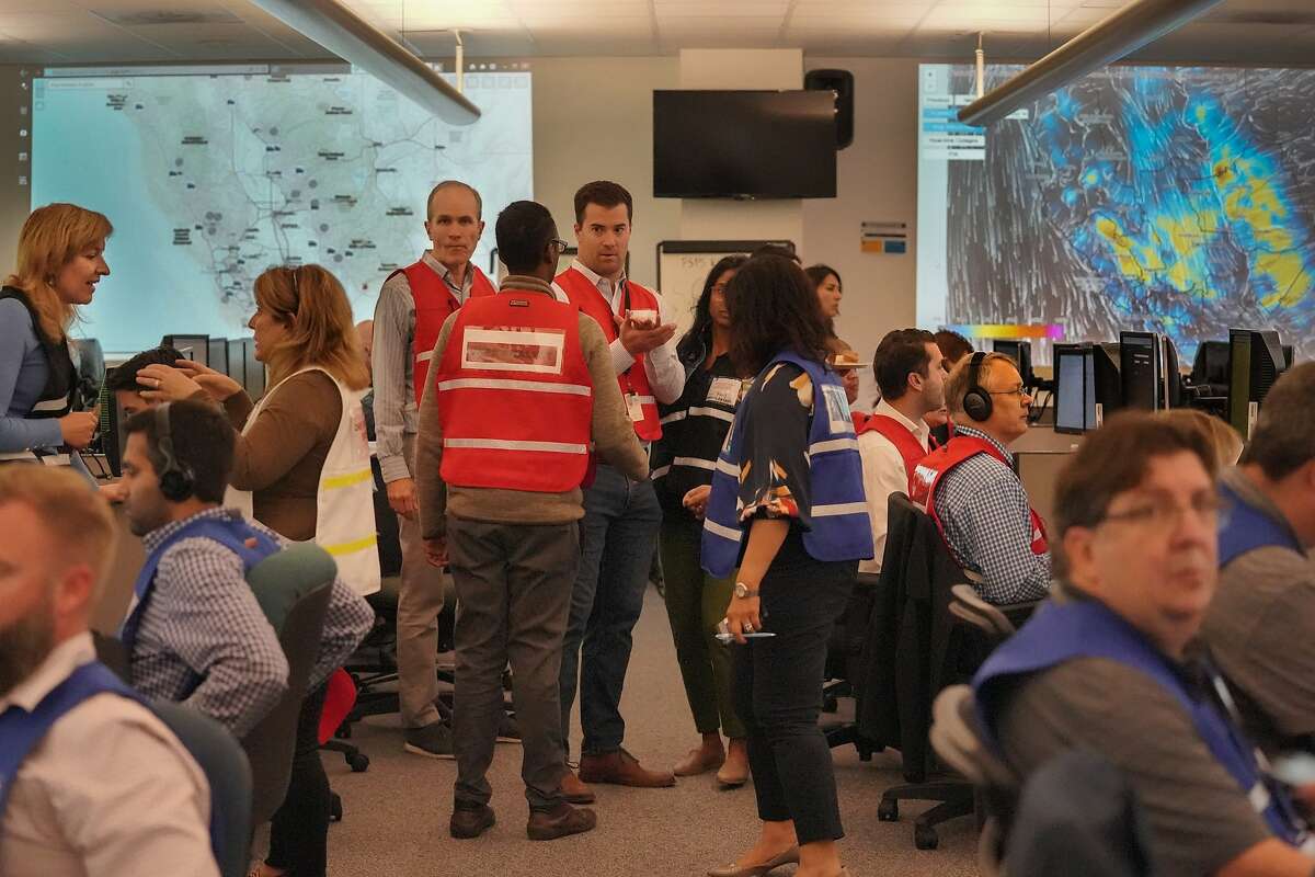 PG&E employees gather at their emergency operations center where public safety shutoff was confirmed for nearly 800,000 customers in Calif. on Tuesday, Oct. 8, 2019 in San Francisco, Calif.