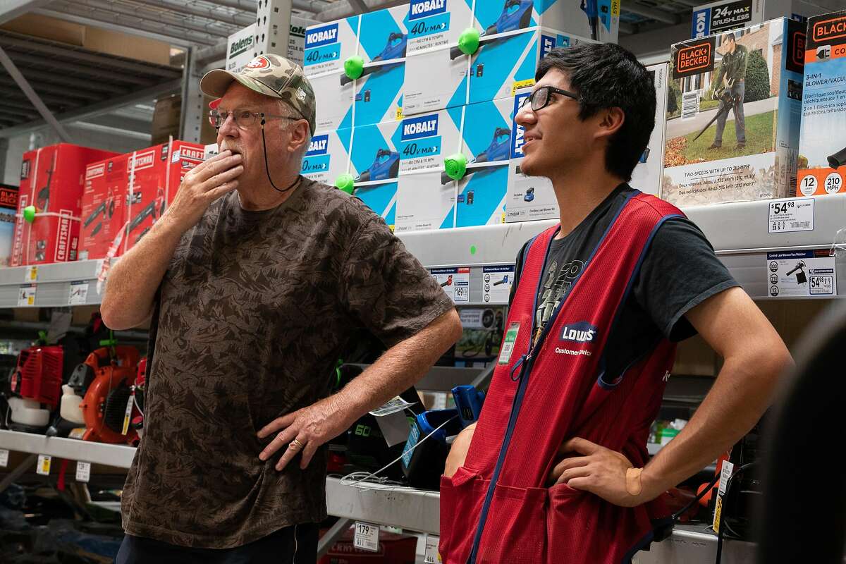 Don Maben of Pittsburg, left, speaks with Lowe's employee, Jesus Villalobos about purchasing a generator at Lowe's in Antioch, Calif., on Tuesday, Oct. 8, 2019.