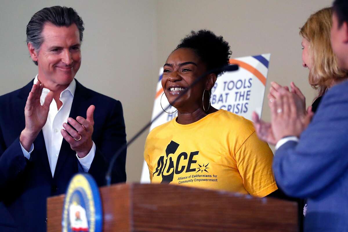 ACCE Action member Sasha Graham is applauded after speaking before California Governor Gavin Newsom signs AB1482, a statewide rent cap bill, at West Oakland Senior Center in Oakland, Calif., on Tuesday, October 8, 2019.