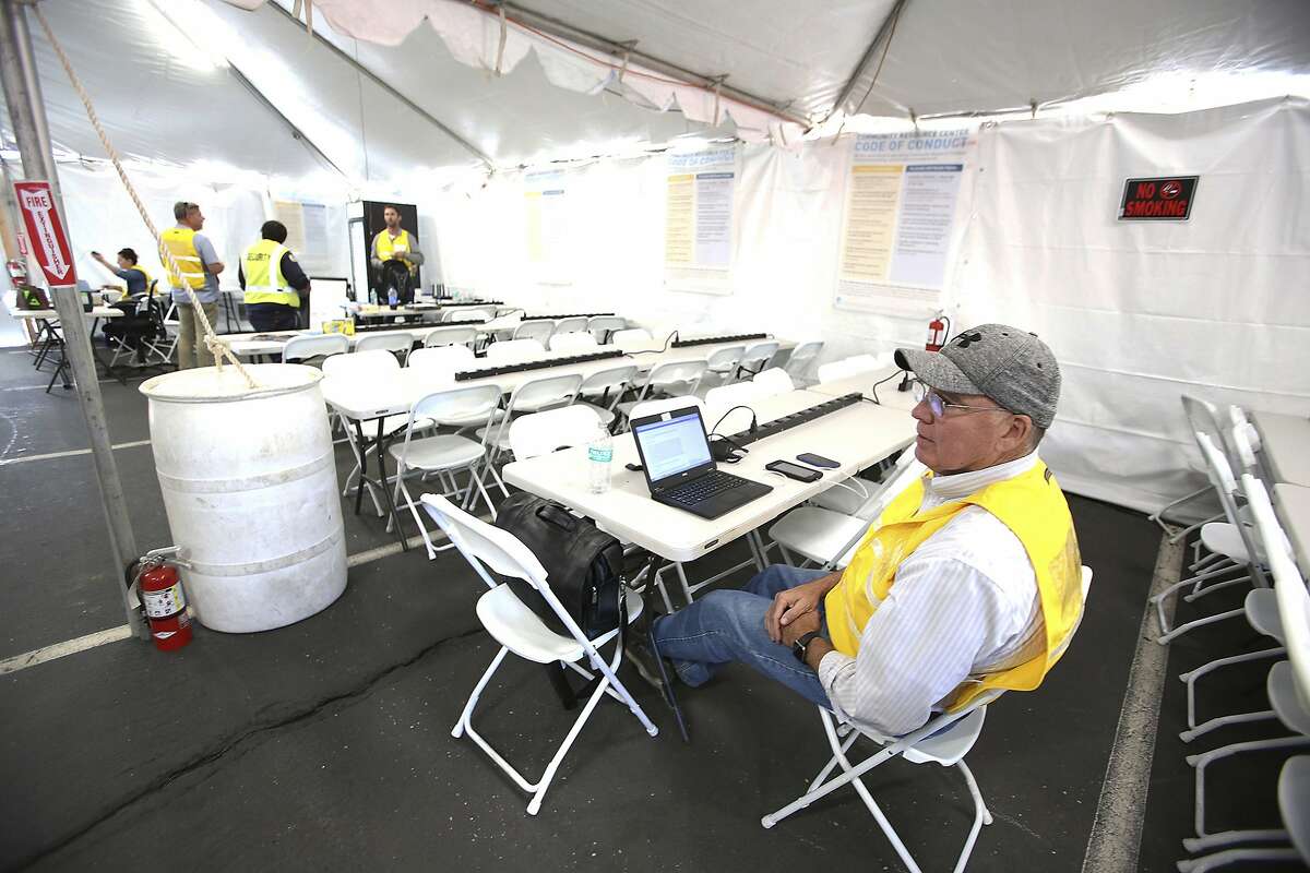 Pacific Gas & Electric customer experience manager Don Hall sits in the Community Resource Center, set up at Sierra College, in Grass Valley, Calif., for those whose power was shut down as part of a planned power shutdown due to increased wildfire risk. (Elias Funez/The Union via AP)