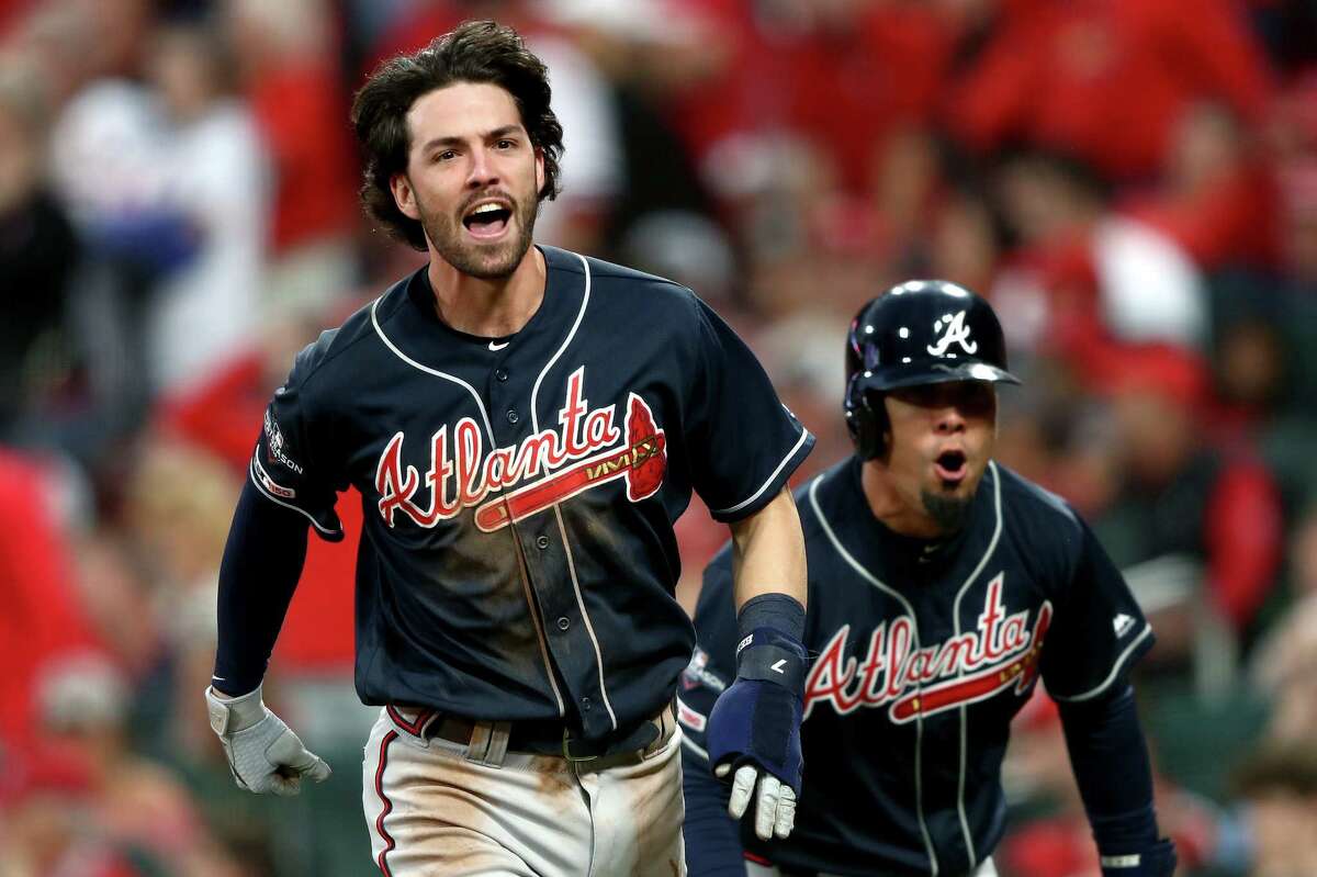 Dansby Swanson of the Atlanta Braves celebrates as he rounds the