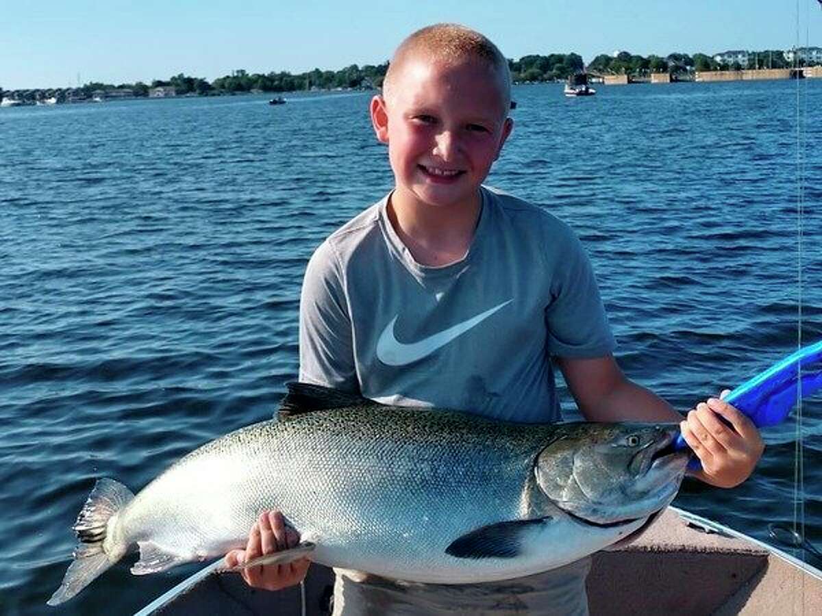 Cooper Higgins, son of Evart's Paul Higgins, shows a king salmon caught during the summer. (Courtesy photo)