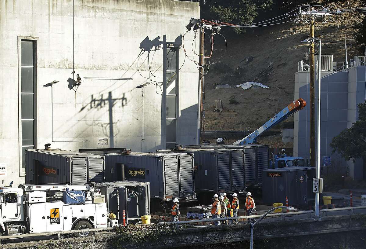 Crews work to connect generators in effort to keep the Caldecott Tunnel open to traffic during a possible power outage at noon on Wednesday, Oct. 9, 2019, in Oakland, Calif. Pacific Gas & Electric has cut power to more than half a million customers in Northern California hoping to prevent wildfires during dry, windy weather throughout the region. (AP Photo/Ben Margot)