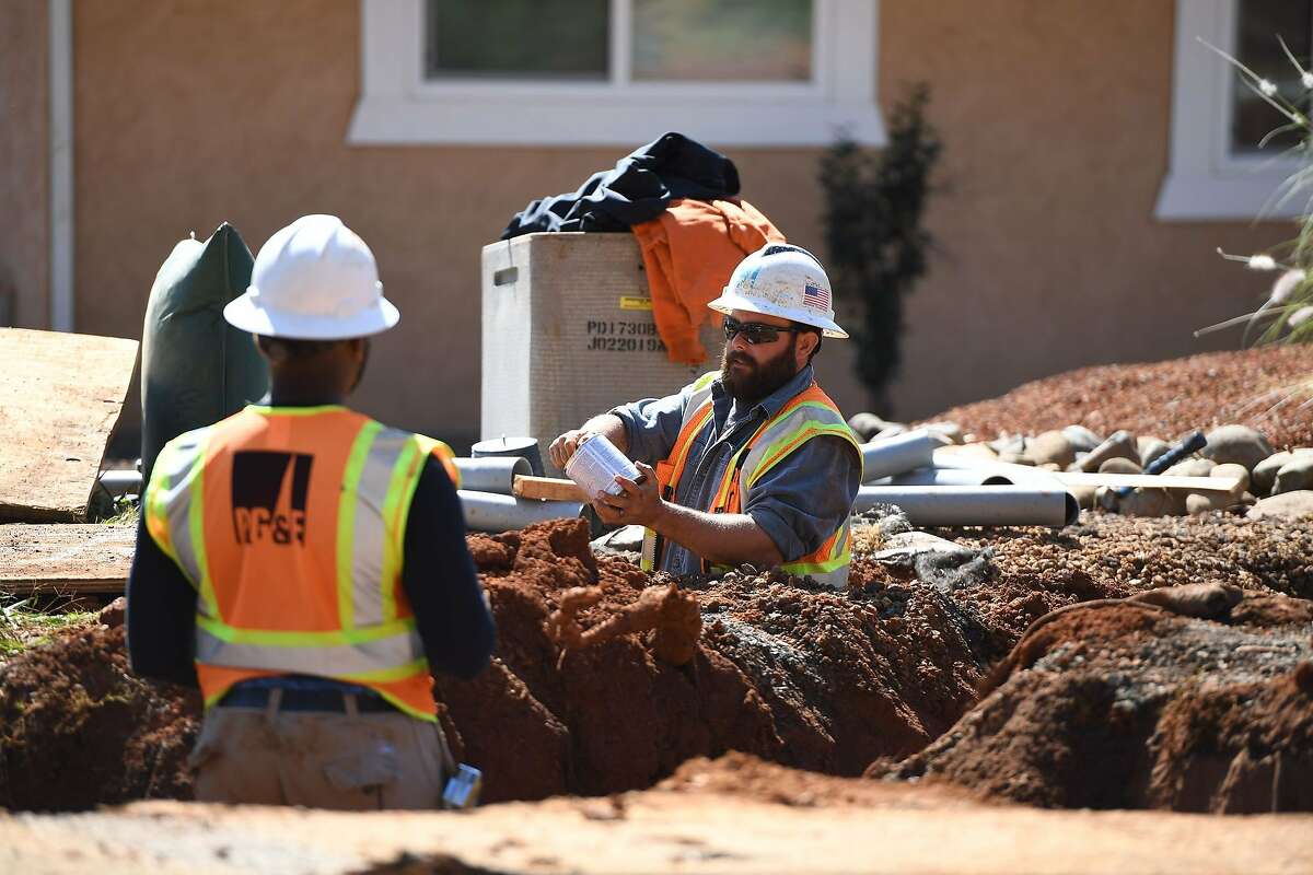 Pacific Gas & Electric Co. (PG&E) workers install conduit in trenches for underground electric lines in Paradise, California, October 1, 2019. - Rolling blackouts set to affect millions of Californians began as a utility company started switching off power to an unprecedented number of households in the face of windy weather that raises the risk of wildfires. Pacific Gas & Electric, which announced the deliberate outage, is working to prevent a repeat of a catastrophe last November in which faulty power lines it owned were determined to have sparked California's deadliest wildfire in modern history.