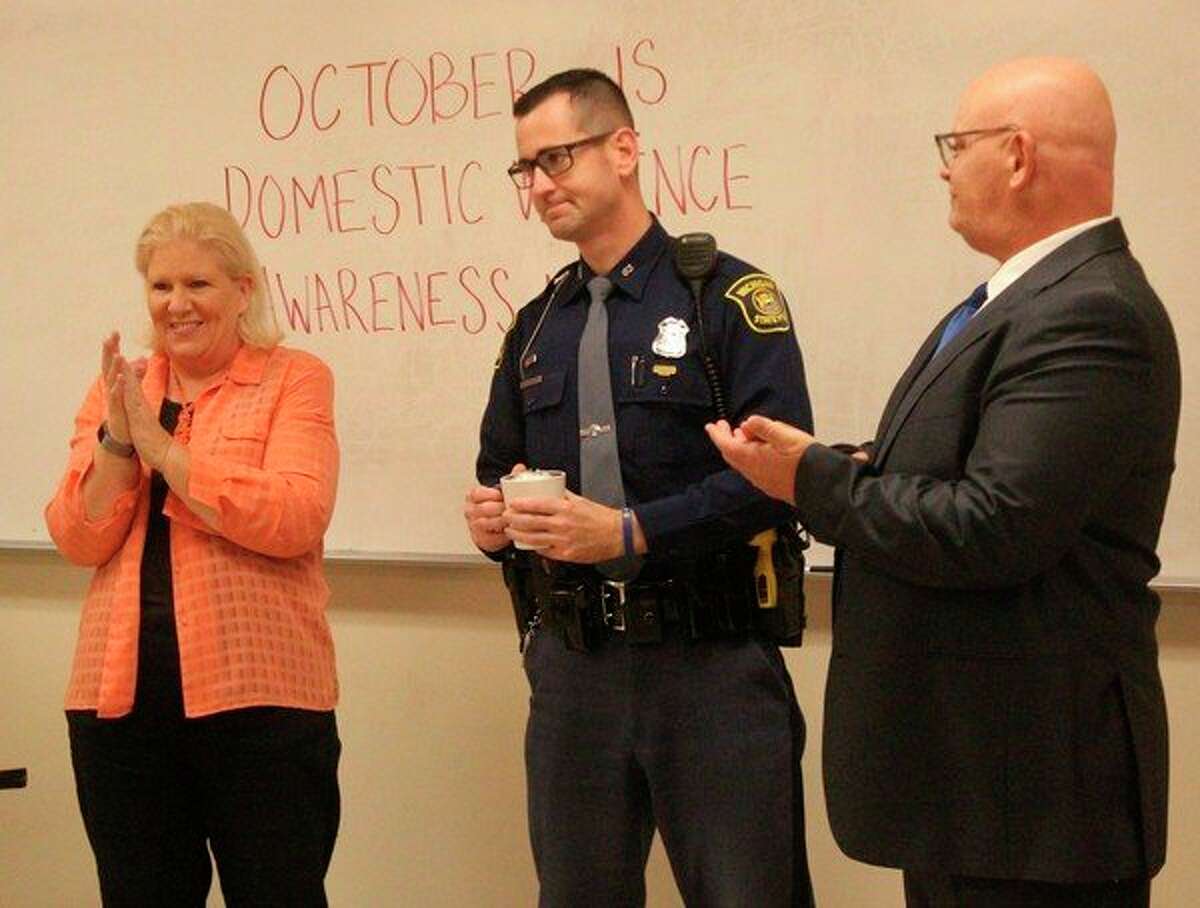 Teresa Mora (left), Women's Information Services, Inc. Osceola County domestic violence outreach coordinator, recognized Michigan State Police Trooper Brian Lucha (center), Osceola County Assistant Prosecutor Cameron Harwell (right) and Mecosta County 77th District Court Judge Peter Jaklevic (not pictured) for their work helping survivors of domestic violence and sexual assault in Mecosta and Osceola counties during a WISE Domestic Violence Response Team meeting on Wednesday at the Big Rapids Department of Public Safety. (Herald Review photo/Taylor Fussman)