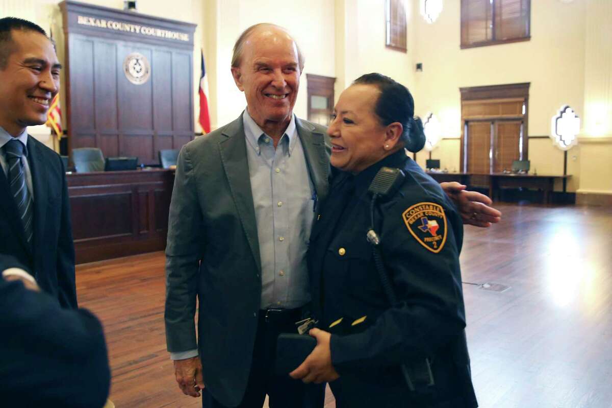 Bexar County Judge Nelson Wolff congratulate Sheriff's Deputy Leticia Vazquez before she is sworn in as the Precinct 2 Constable on Wednesday. Judge Peter Sakai administered the oath of office. Vazquez replaces Michelle Barrientes, who is under investigation by the FBI and Texas Rangers.