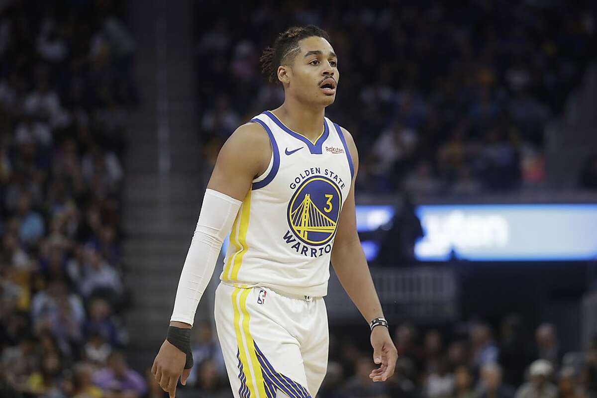 Golden State Warriors' Jordan Poole (3) reacts to San Francisco 49ers'  Deebo Samuel on the sideline after hitting a shot in the second half of an  NBA basketball game against the Memphis