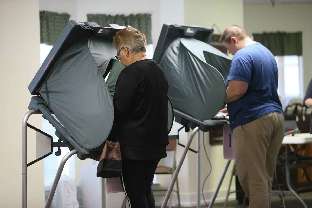 Voters fill out their ballots at a polling station in Houston, Texas.