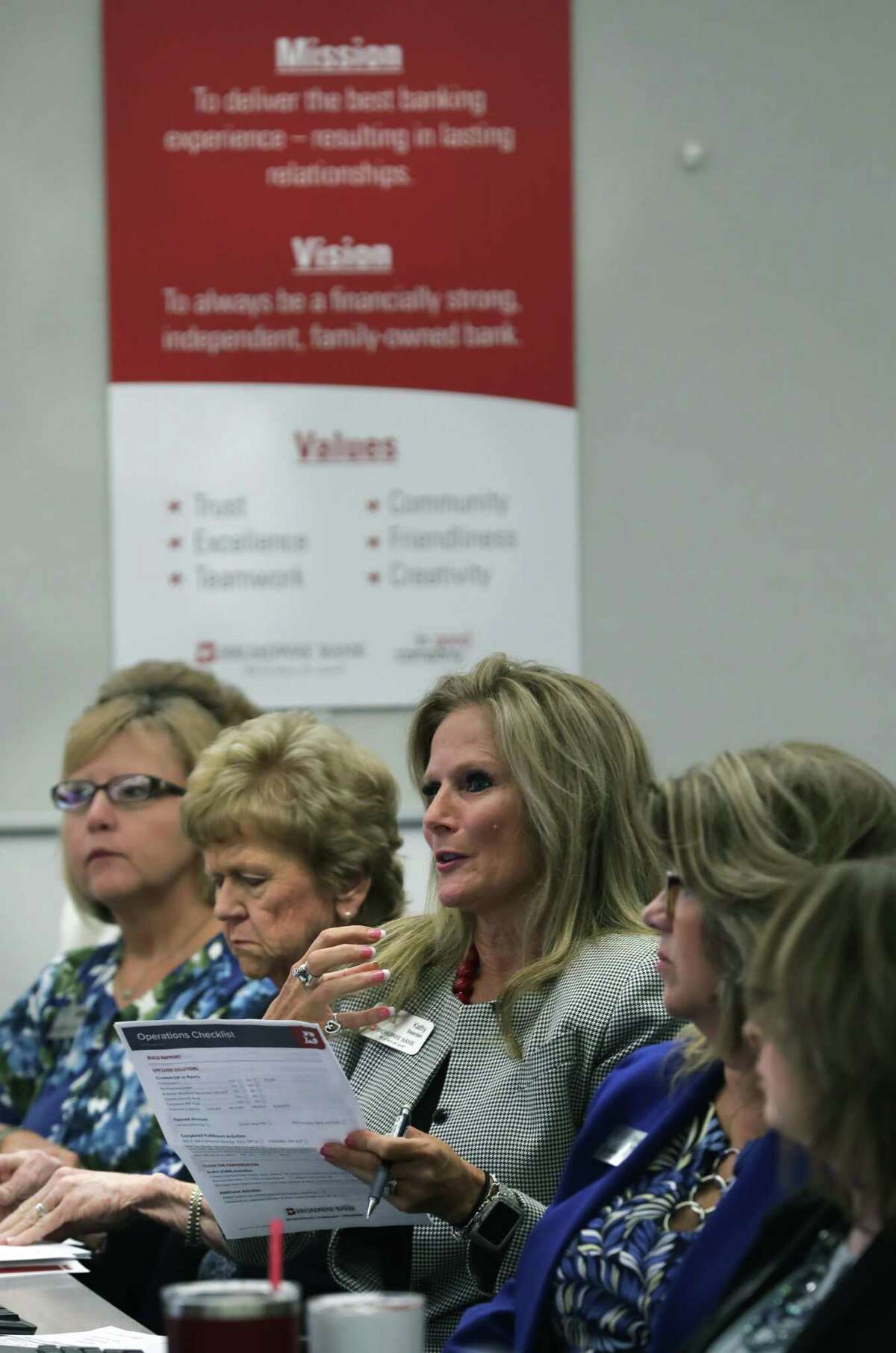 Kathy Bearden-Porter, center, a financial center manager at Broadway Bank, makes a point during a training session. For the second straight year, Broadway Bank has earned the Top Workplace honor for large employers with at least 500 workers.