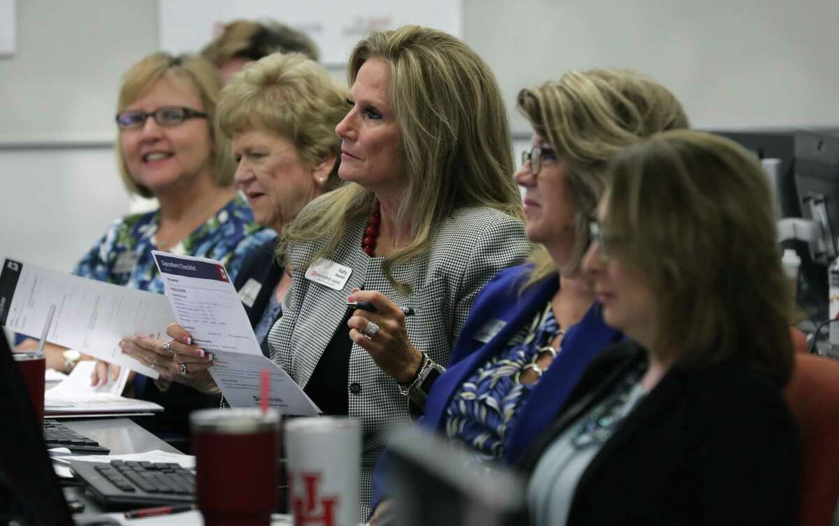 Kathy Bearden-Porter, center, a financial center manager at Broadway Bank, and other employees, attend a training session.