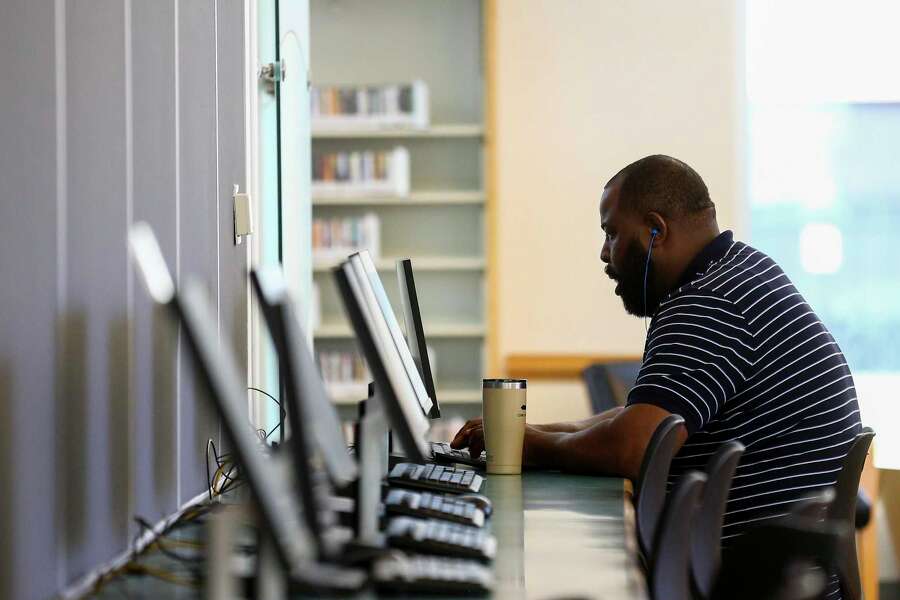 Lionel Garr uses a computer at the McGovern-Stella Link Library Tuesday, Oct. 1, 2019, in Houston. Two years ago, this library was one of 12 library branches in Houston and Harris County to close due to water damage from Hurricane Harvey.