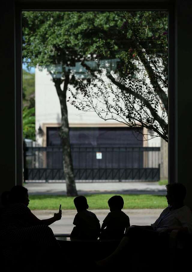 Two toddlers play on a table inside the McGovern-Stella Link Library Tuesday, Oct. 1, 2019, in Houston. Two years ago, this library was one of 12 library branches in Houston and Harris County to close due to water damage from Hurricane Harvey.