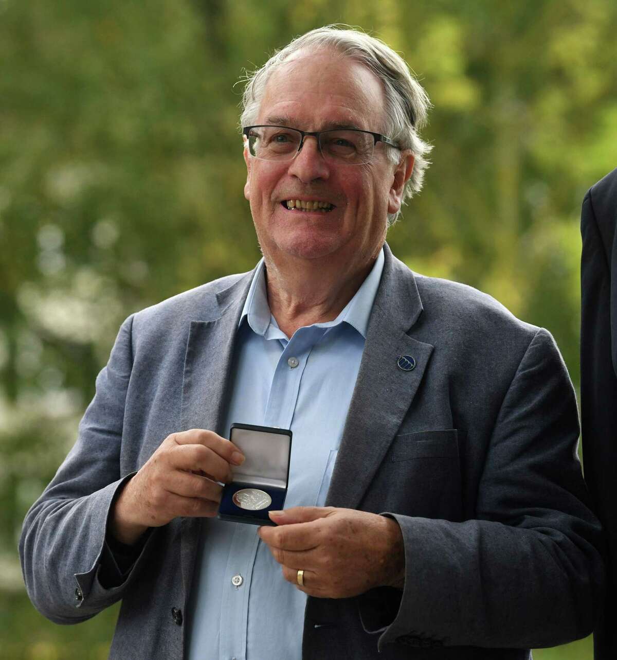 2019 Nobel Prize Laureate in Chemistry, British Stanley Whittingham, poses with the Einstein medal, after being awarded by the mayor of Ulm (unseen), in Ulm, southern Germany, on October 9, 2019. - John Goodenough of the US, Britain's Stanley Whittingham and Japan's Akira Yoshino won the 2019 Nobel Chemistry Prize for the development of lithium-ion batteries, the Royal Swedish Academy of Sciences in Stockholm, Sweden, said. (Photo by Christof STACHE / AFP) (Photo by CHRISTOF STACHE/AFP via Getty Images)
