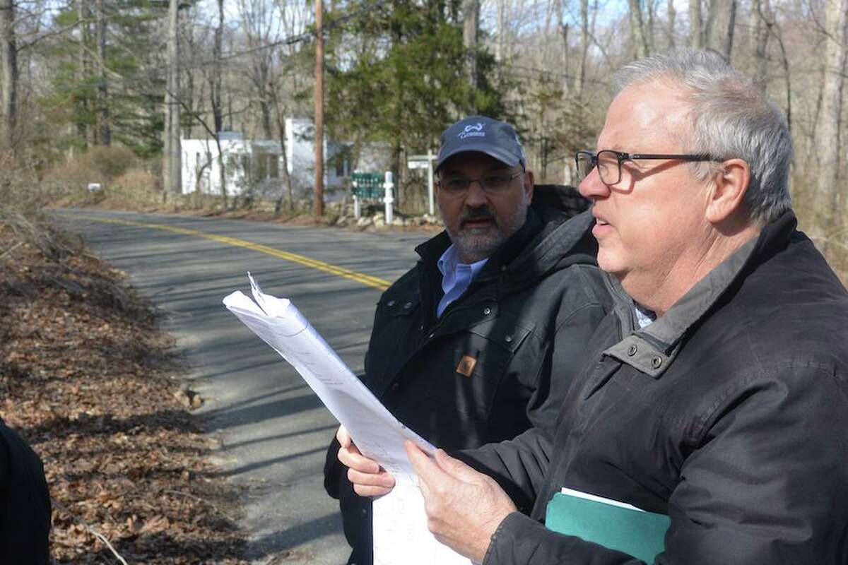 Wilton Town Planner Bob Nerney, right, looks over plans with Planning and Zoning Commissioner Richard Tomasetti at a site walk in Cannondale. Nerney is leaving Wilton after 18 years of service.