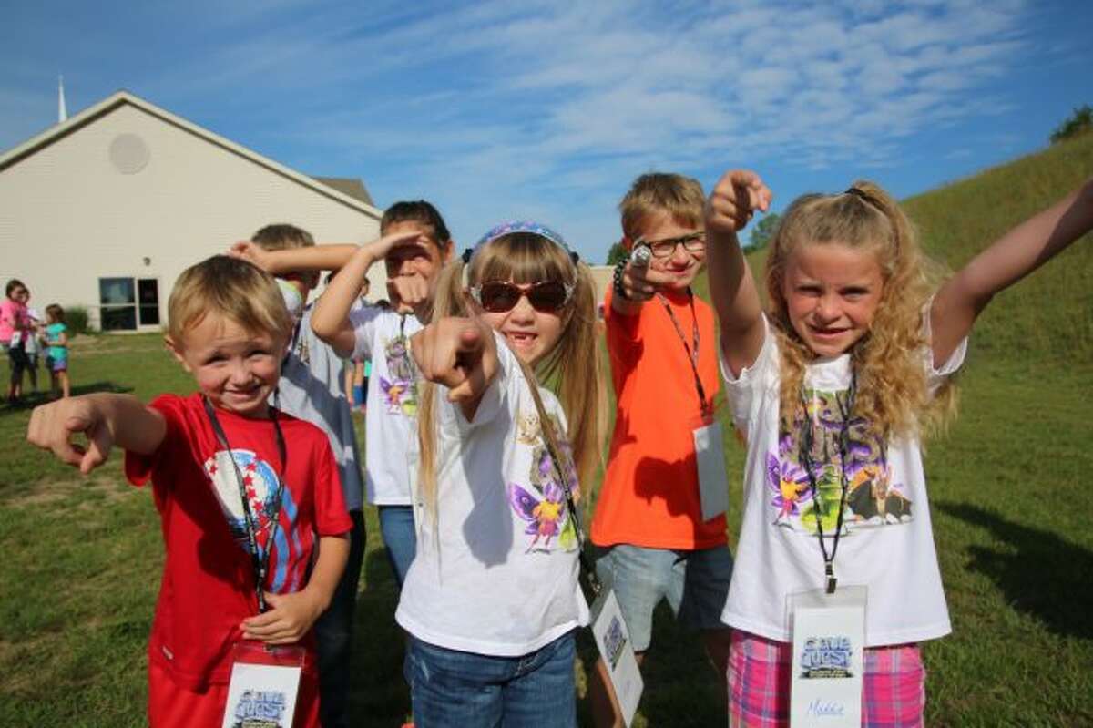 THUMBS UP: Kids smile while participating in Trinity’s Cave Quest VBS program on Monday. The program is an adventure designed to ground kids in the rock-solid foundation of God’s love.