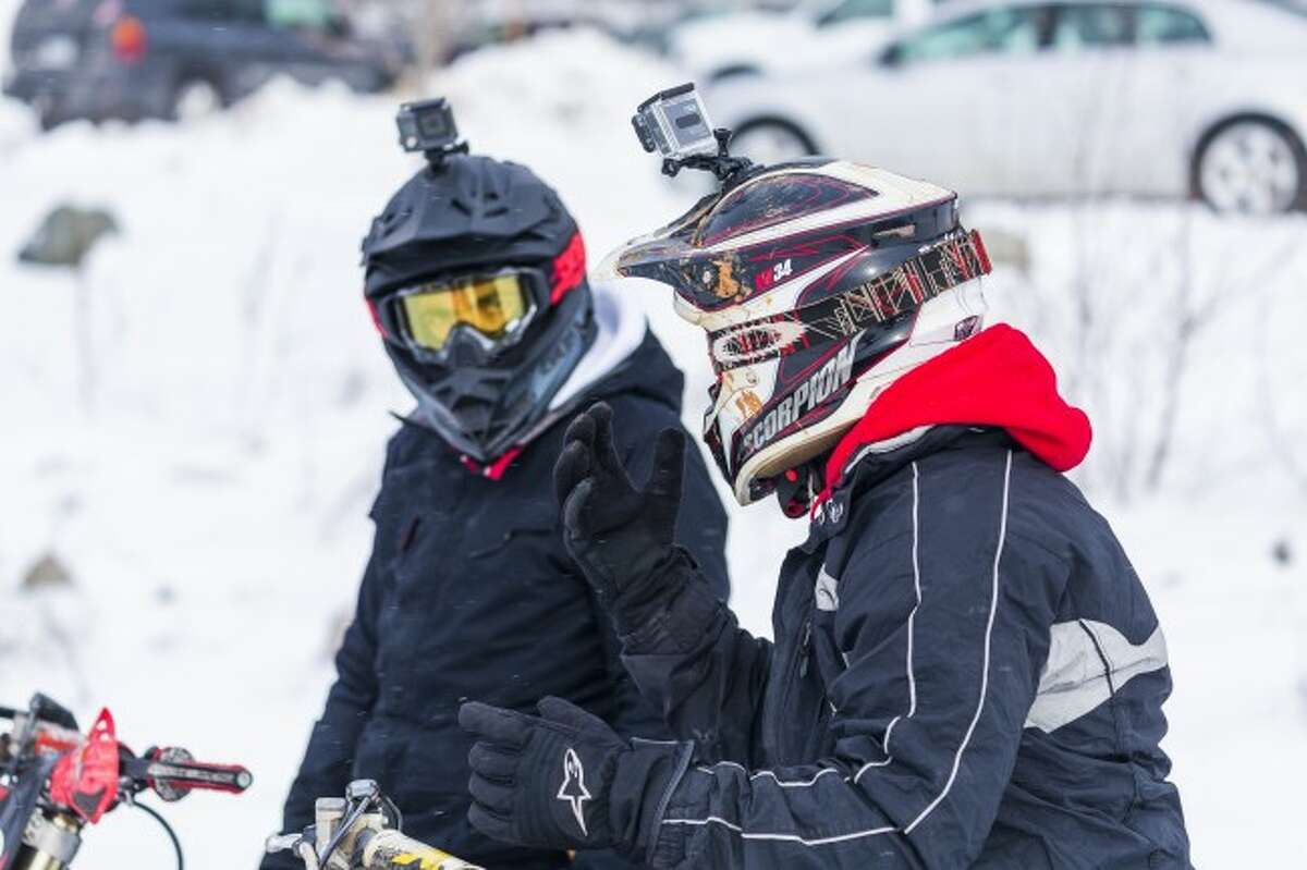 RACING IN WINTER: Riders bundle up in heavy winter gear and helmets for safety and warmth while riding during the winter months. They also attach GoPro cameras to their bikes or helmets to record the ride.