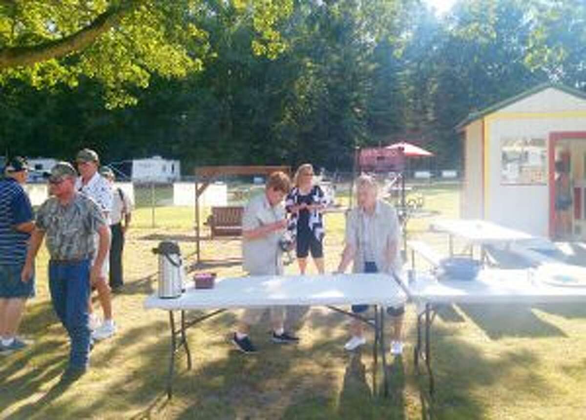 CEREMONY: Rose Lake County Park staff members prepare for the dedication ceremony of the mini golf course restoration project on Tuesday, Aug. 16.