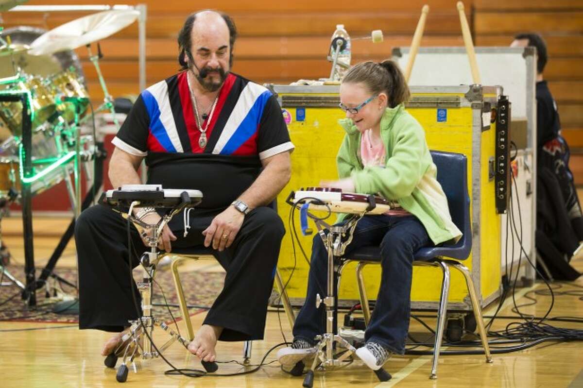 FINDING RHYTHM: Fourth-grade student Natalie Hebert plays the wave drum next to Gottfried during the entertaining event, where Gottfried also talked about avoiding drugs, bullying and other hard-hitting topics.