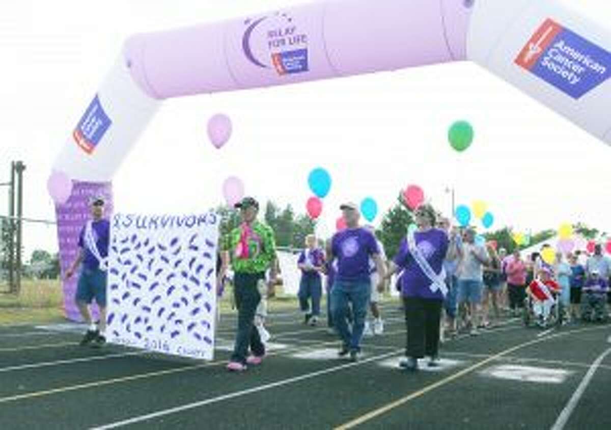 SURVIVORS’ WALK: Cancer survivors and their caregivers walked in solidarity before enjoying a special dinner together during the Relay for Life event on Saturday at the Osceola County Fairgrounds.
