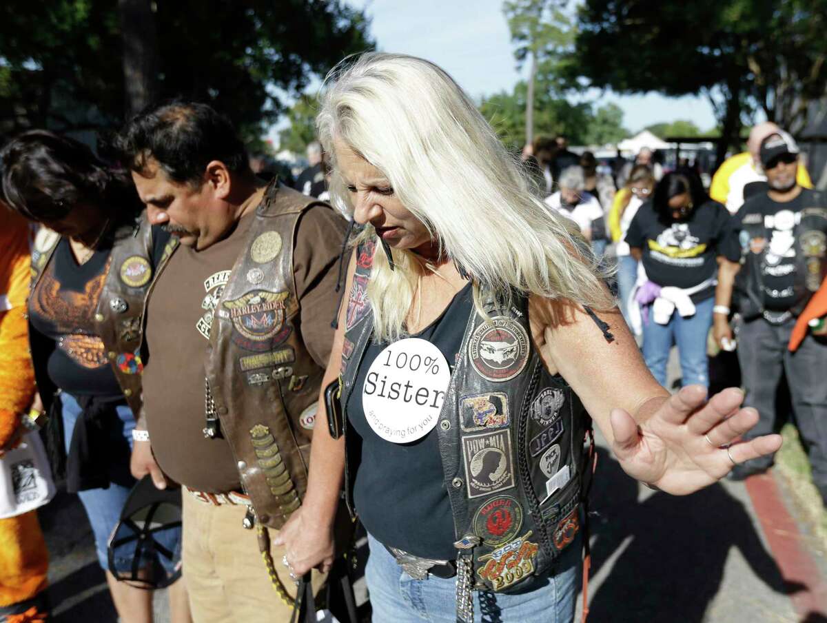 Gloria Valdez, left, and Roland Hinojosa, center, both with Warriors Bikers for Christ Motorcycle Ministry, and Joan Wynn, right, of JLBB ( Jesus Lovin' Bikers serving Bikers) Motorcycle Ministry pray before the start of the 11th Annual Nun Run at St. Austin Center, 2002 S. Wayside Drive, Saturday, Oct. 17, 2015, in Houston. The 40 mile ride to San Leon benefits the CHRISTUS Foundation for HealthCare school-based clinics, which provide healthcare to children on campus in 17 low-income neighborhood schools. ( Melissa Phillip / Houston Chronicle )