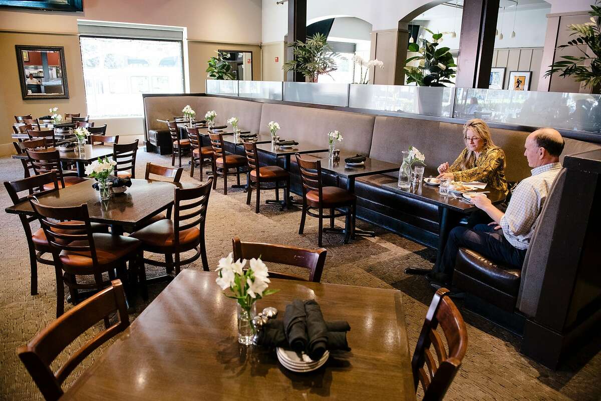 Greg Richardson and Teresa Anthony of nearby Gel Company have the dining room almost entirely to themselves during a lunch meeting at Momo's restaurant in San Francisco, California, on Friday, Oct. 4, 2019.