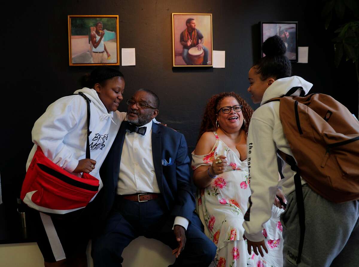 Rev. Arnold Townsend, and his daughter, Natalie Douglas, seated, greet Kayla Sherman, left, and Jasmin Corley, right, at the African American Arts & Culture Complex in San Francisco, Calif., on Monday, September 9, 2019. Townsend, a well-known leader in SF's NAACP and black church community, was devastated when his 30-something daughter died last year. But almost immediately, he received an email from Ancestry.com showing he had another daughter he knew nothing about. Douglas, a star singer, was this unknown daughter.