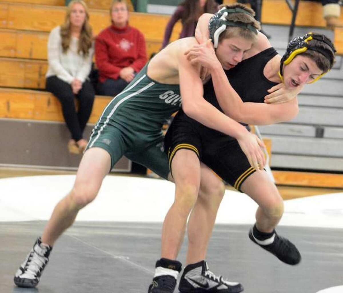 Photo by Dave Phillips Guilford's Andrew Ignato and Amity's Jake Cala tangle during their 120-pound match Wednesday night. Ignato won by pin in 5:46.