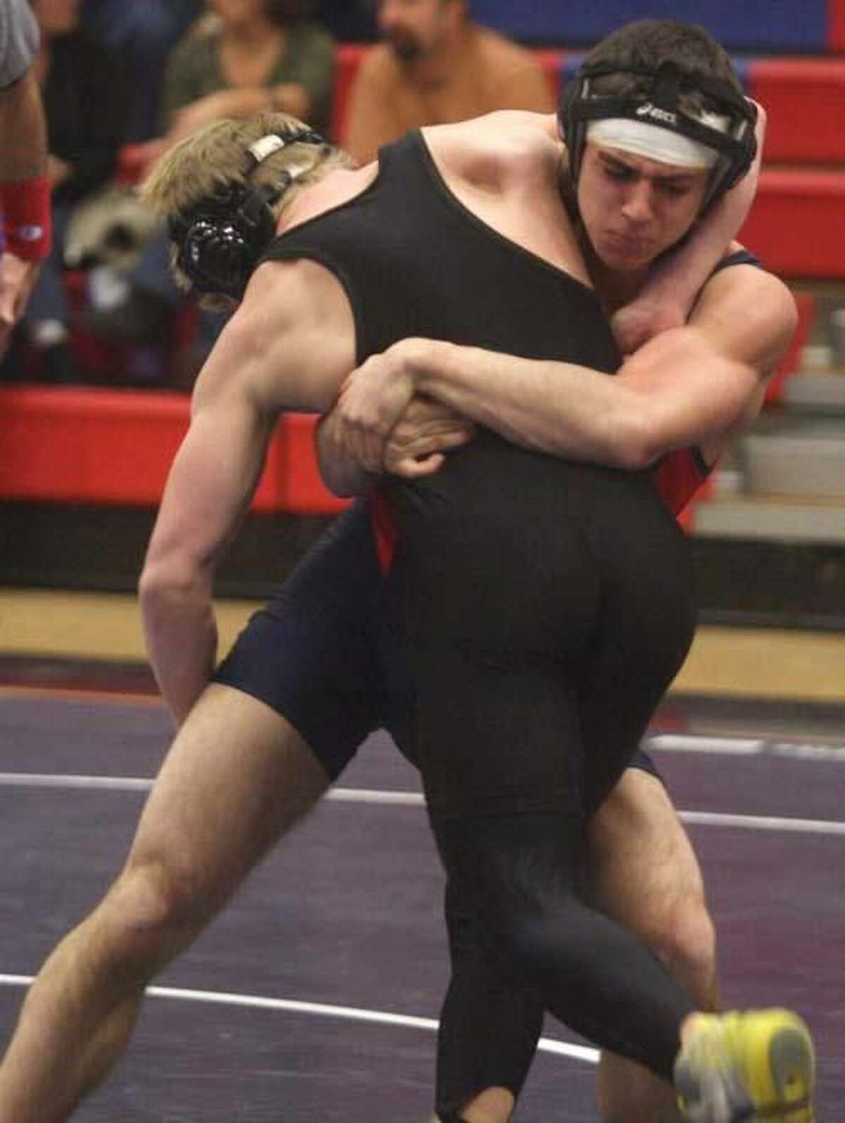 Photo by Russ McCreven Foran's Rick Garcia wraps up Law’s Tylor Baker in their 140-pound match.