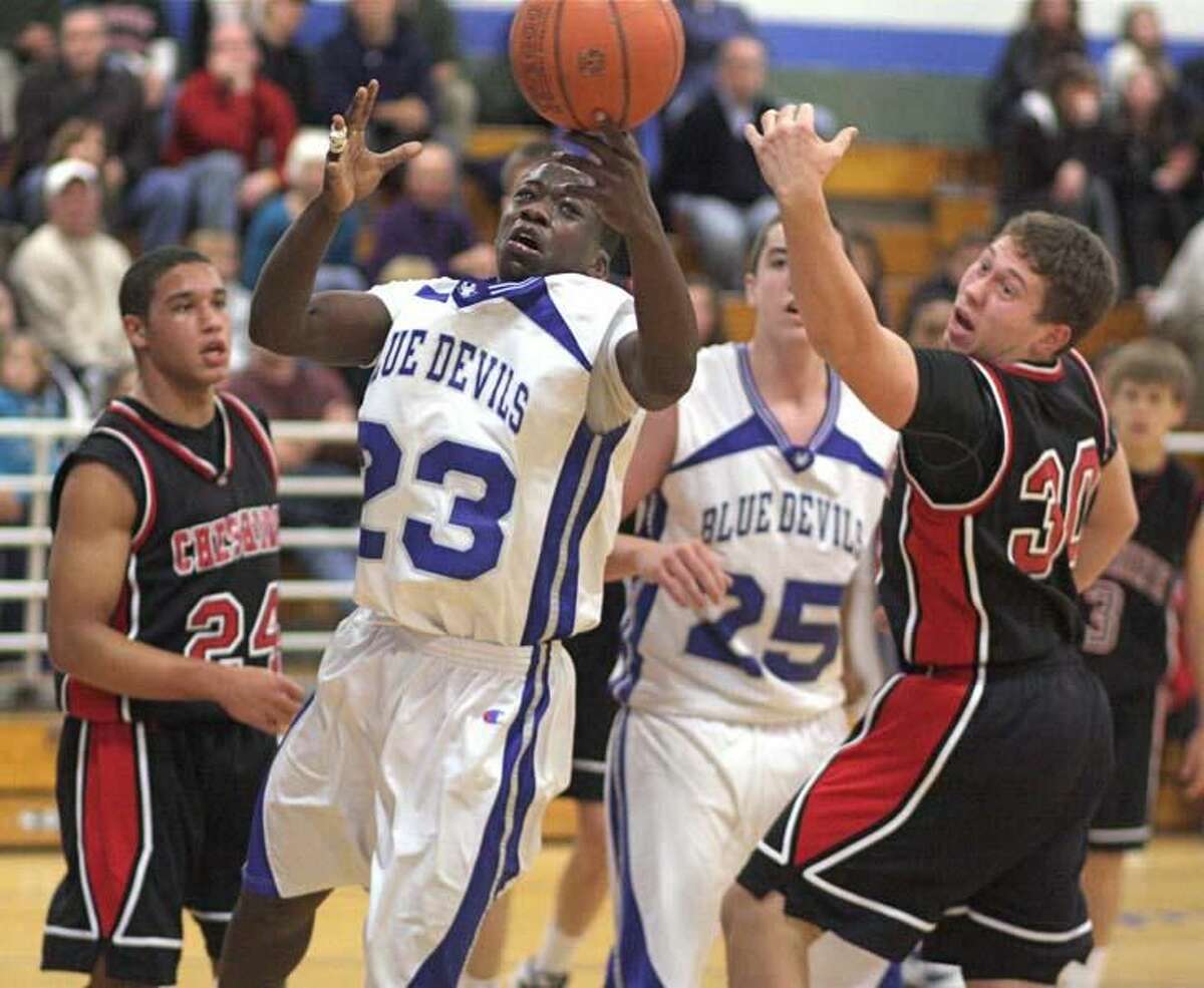 Photo by Russ McCreven West Haven's Kadialy Toure (23) scrambles for a loose ball with Cheshire's Billy Weyrauch.