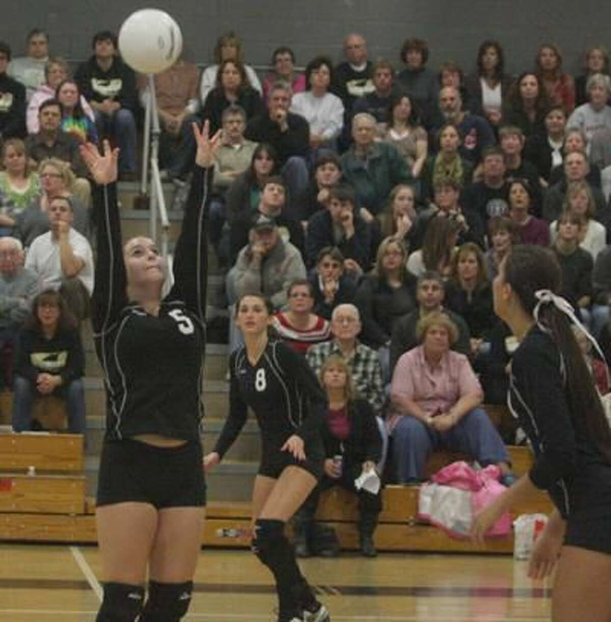 Jonathan Law's Jackie Kochiss sets the ball in the Eagles' 3-1 victory over Woodland in the Class M quarterfinals. (Photo by Russ McCreven)