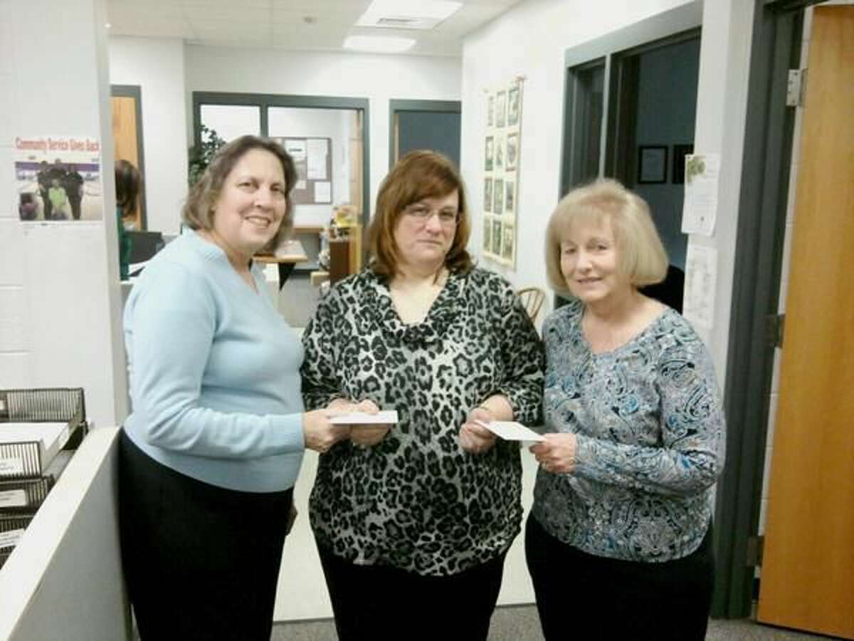 Submitted Photo Susan D’Orso, left, and Maureen Boian, right, of OCW presenting the gift cards to Kim Callahan, center, of Orange Community Services department.