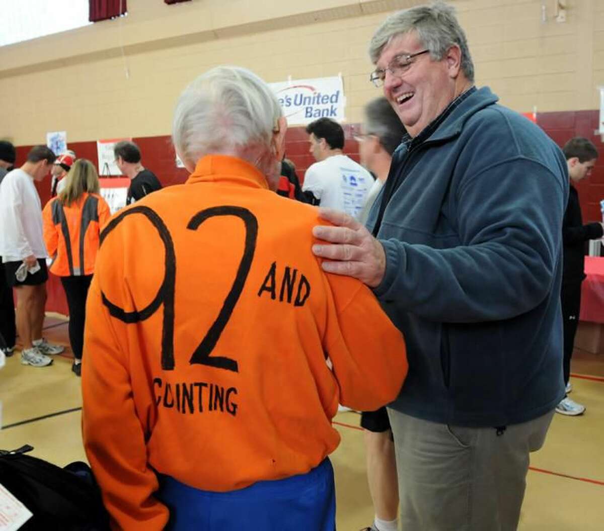 Photos by Mara Lavitt - Orange First Selectman Jim Zeoli congratulates former Orange resident George Whitney on finishing the race. Whitney is 92 years young.