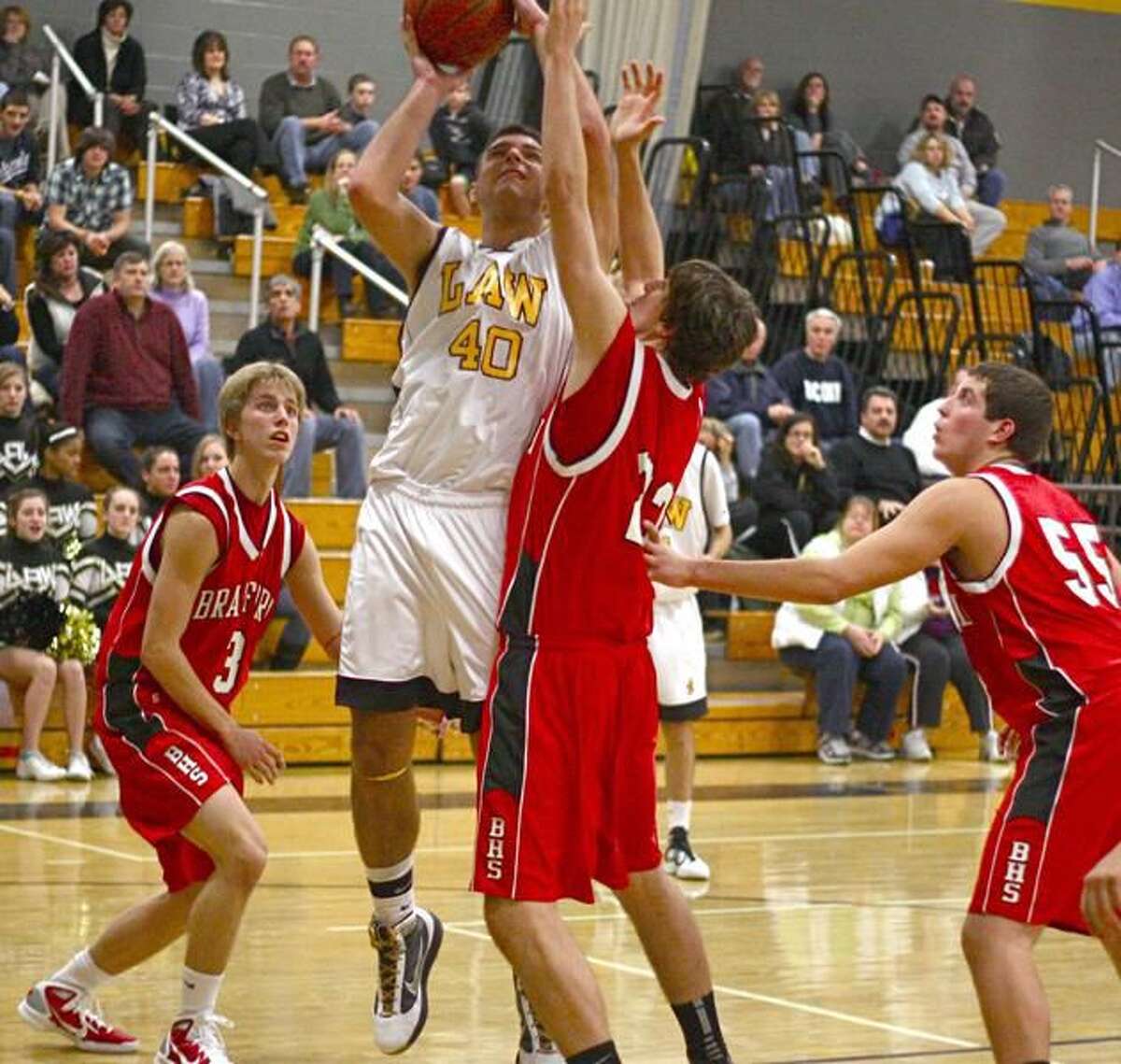 Photo by Russ McCreven Law's Nick Toto powers his way inside to take a shot against Branford in an early-season game. Toto scored a game-high 34 points to lead the Lawmen to their first victory, a 75-61 win over Kaynor Tech.