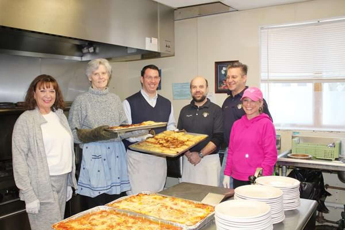 Submitted Photo Milford Superintendent of Schools Elizabeth Feser and Mayor Benjamin G. Blake, center holding trays, joined Devon Rotarians, left to right, Priscilla Lynn, Greyson Schwing, Howard Sadinski, and Erika Shea, at Beth-El Center’s soup kitchen.