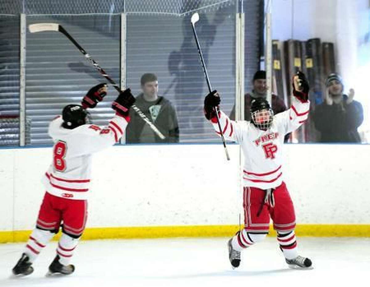 David White (left) and Connor Henry (right) of Fairfield Prep celebrate their first score against Notre Dame of West Haven at the Wonderland of Ice in Bridgeport on 1/7/2012. Henry scored the goal. Photo by Arnold Gold/New Haven Register