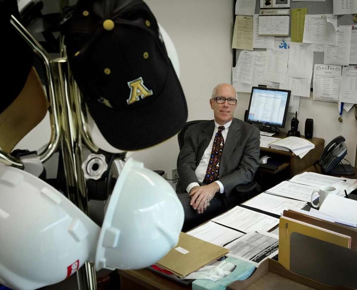 John Brady has worn many hats as Amity Superintendent of school,but he's hanging them all up. Brody is retiring. Melanie Stengel/Register