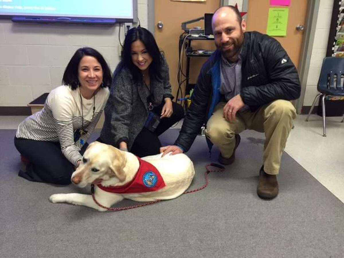 SUBMITTED PHOTO From left, Analisa Sherman, Beecher Road School assistant principal; Teresa Nakouzi, language arts specialist; and Ethan Marin, a parent and the owner of therapy dog.